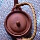 Terracotta and rattan teapot