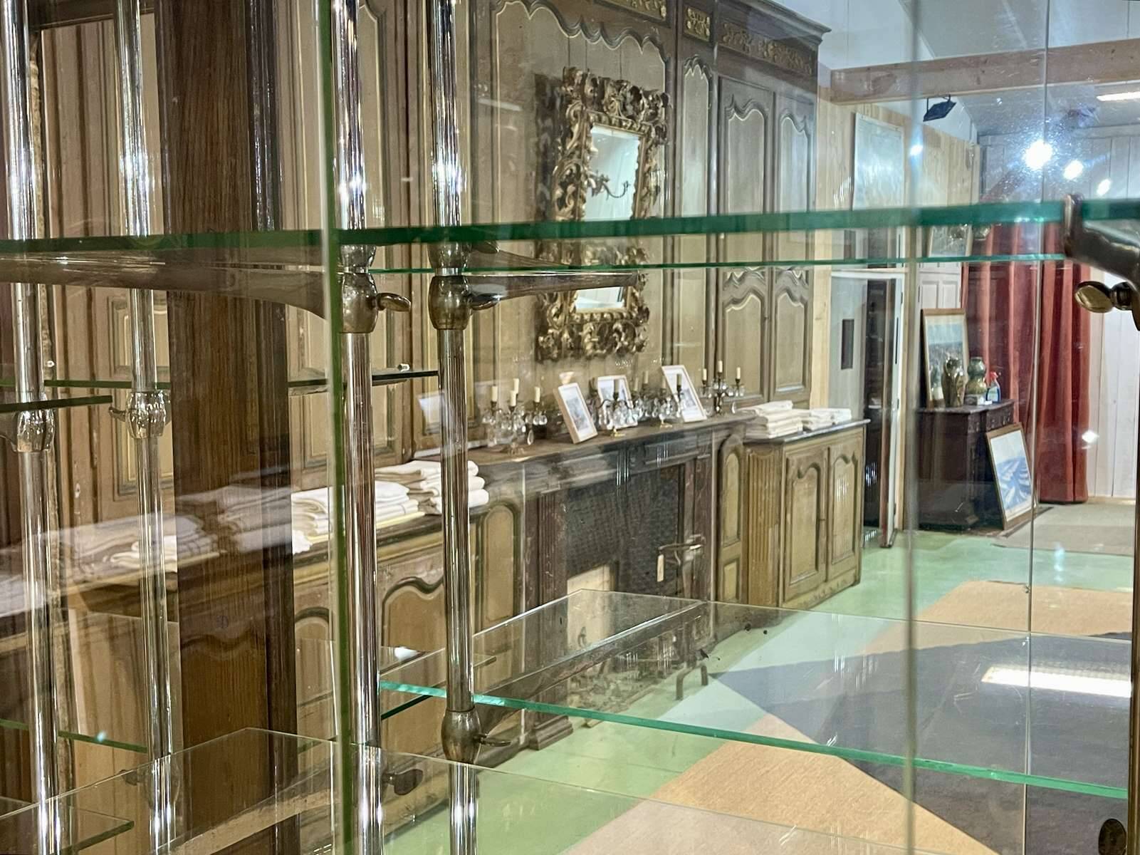 Early 20th-century shop display cabinet in oak with sliding doors.
