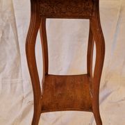 Antique Art Nouveau pedestal table with carved wood and marble top.