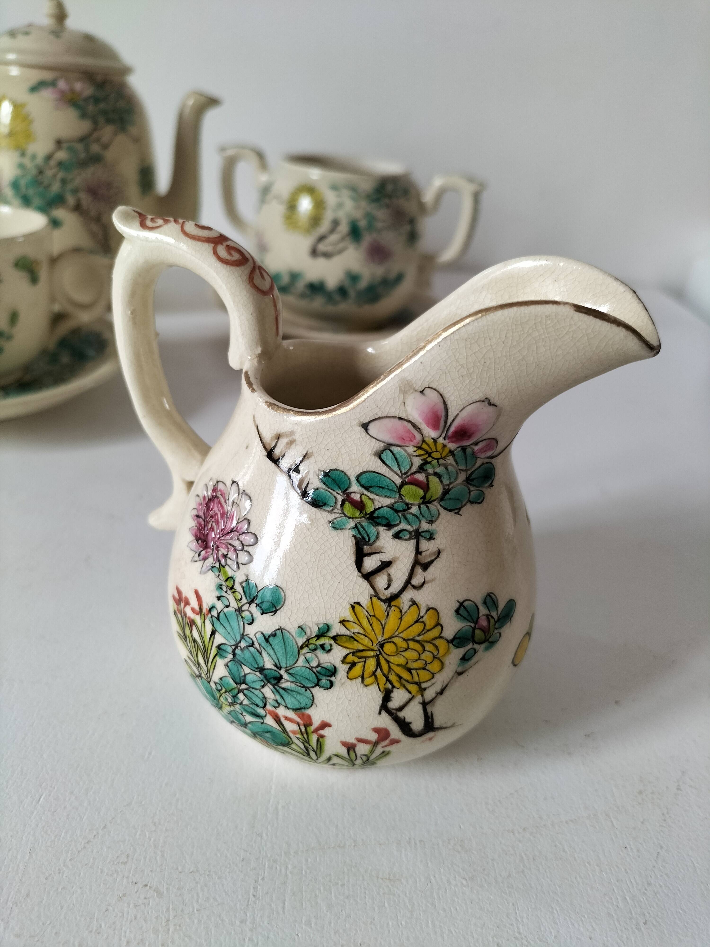 Japanese-style tea set in cracked earthenware with chrysanthemum flowers