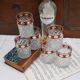 Six pressed glass whisky glasses with red and gold rims