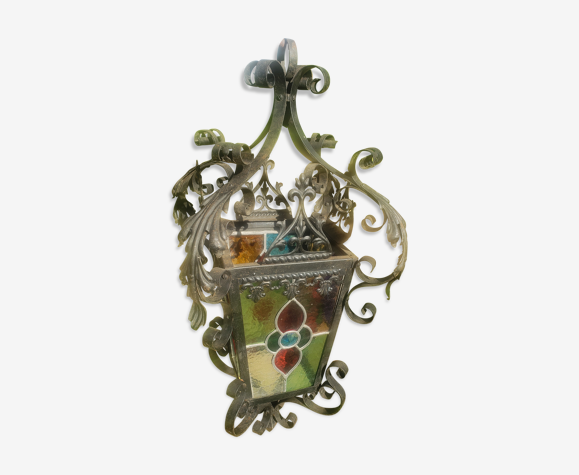Wrought iron garden lantern and stained glass windows