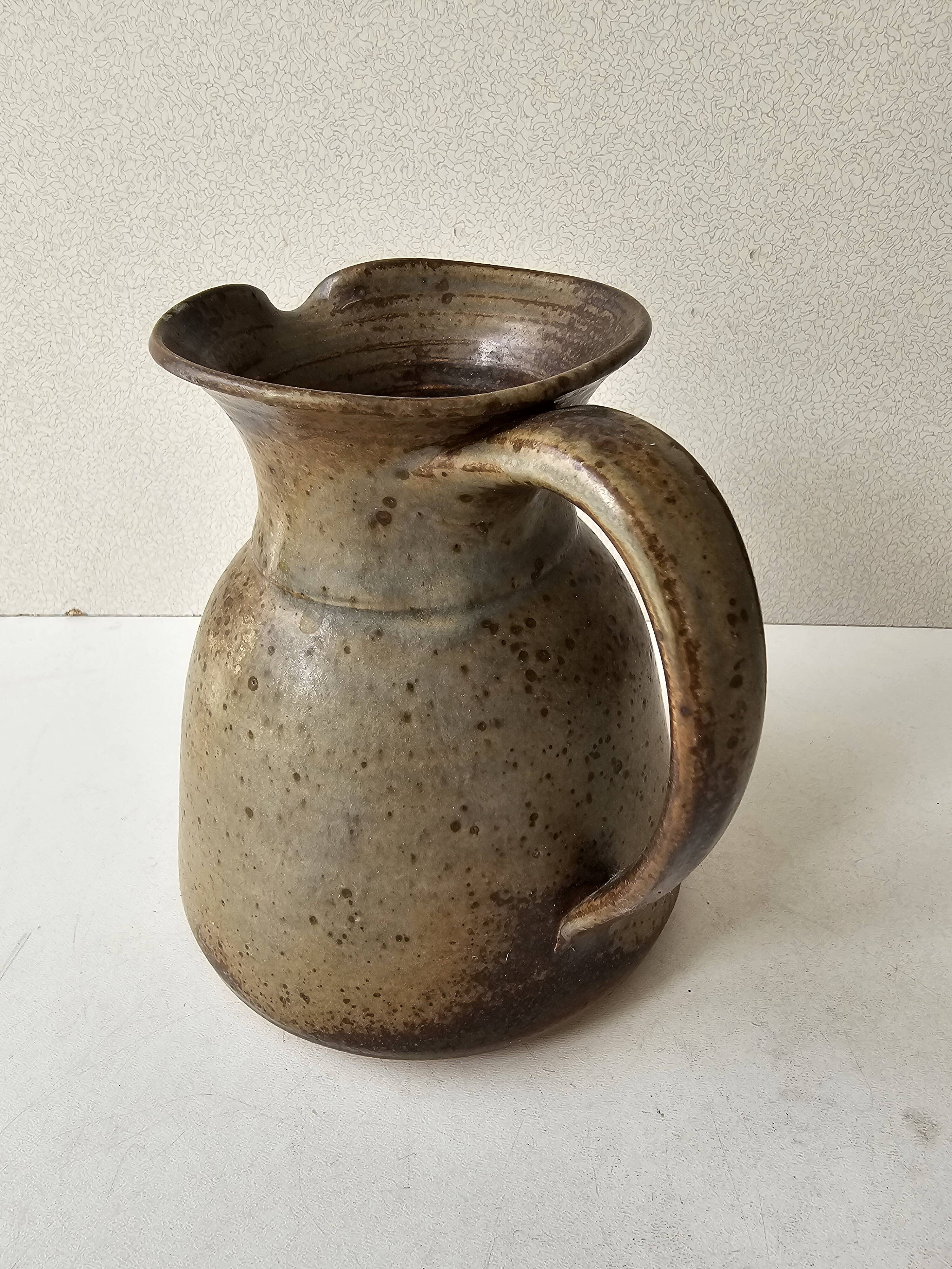 Pyrithed stoneware ceramic pitcher signed GRh. (signature to be identified)