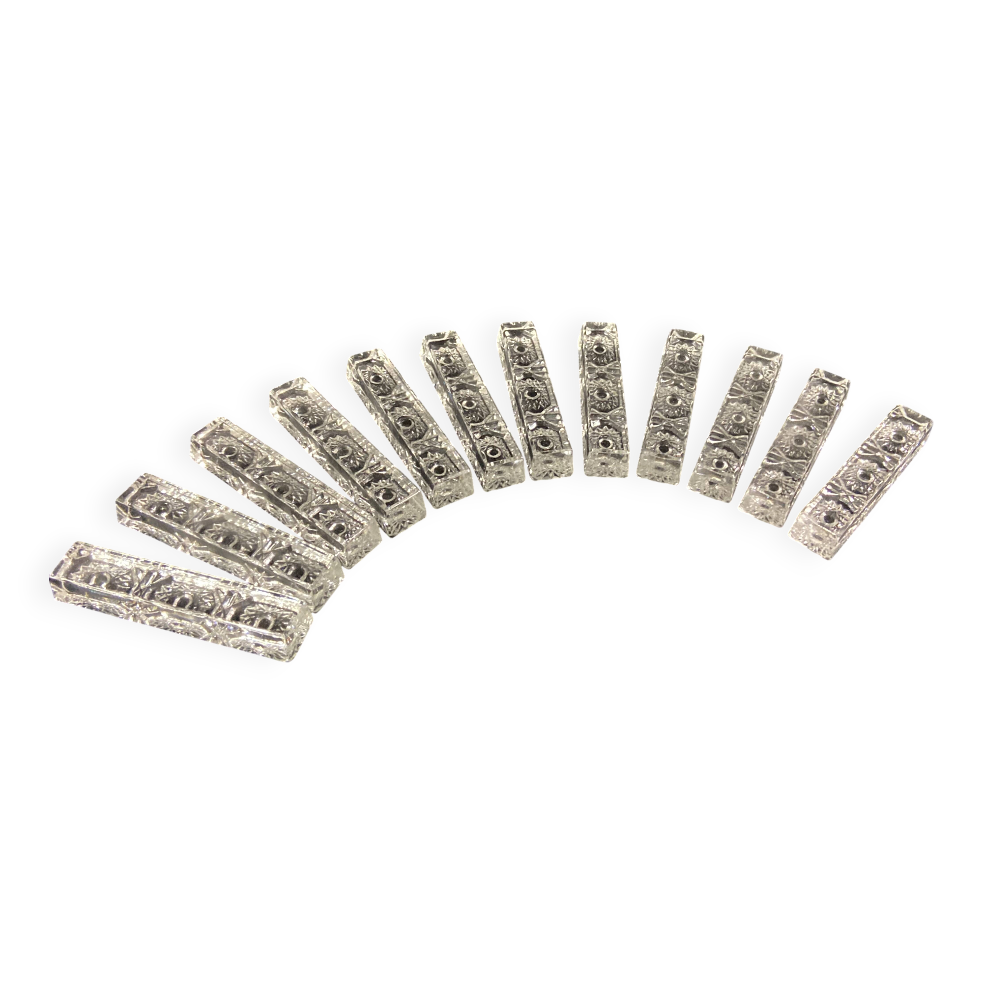 Set of 12 molded glass or crystal knife rests with diamond point decor