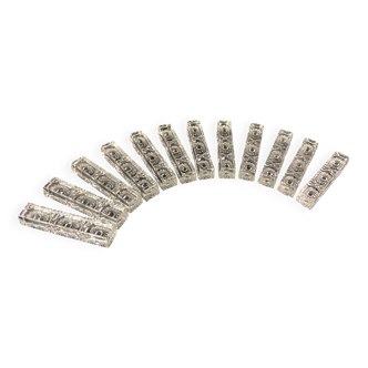 Set of 12 molded glass or crystal knife rests with diamond point decor