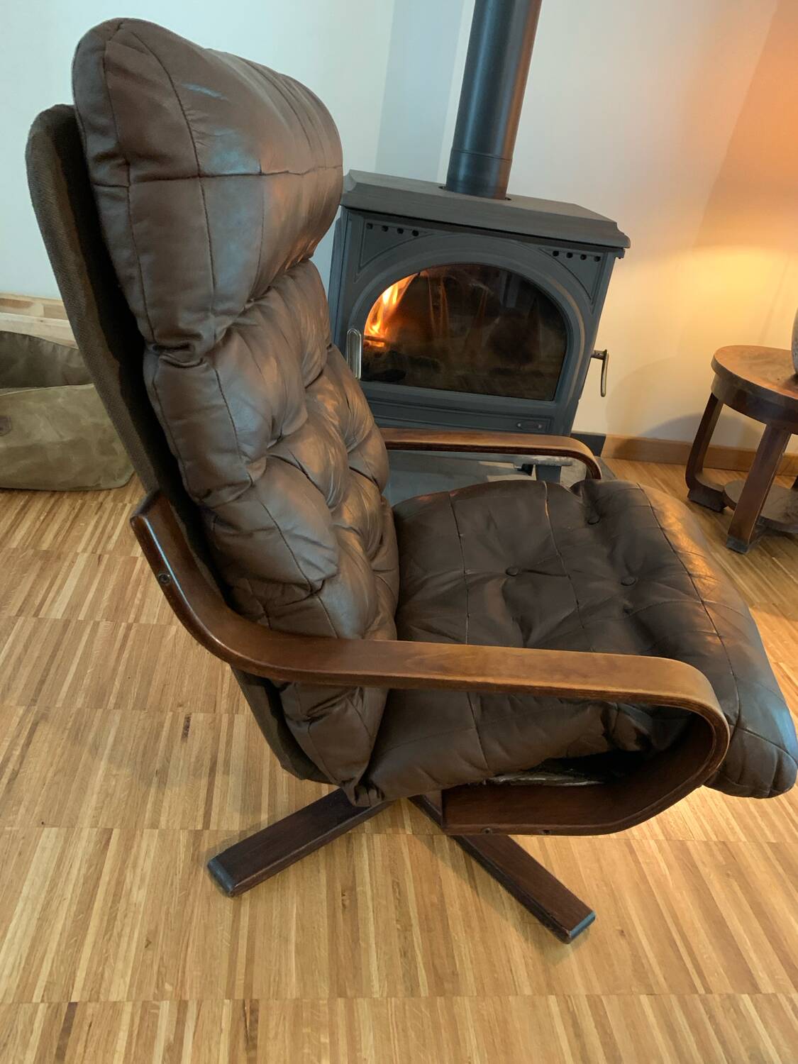 Vintage leather armchair with wooden armrests