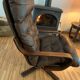 Vintage leather armchair with wooden armrests
