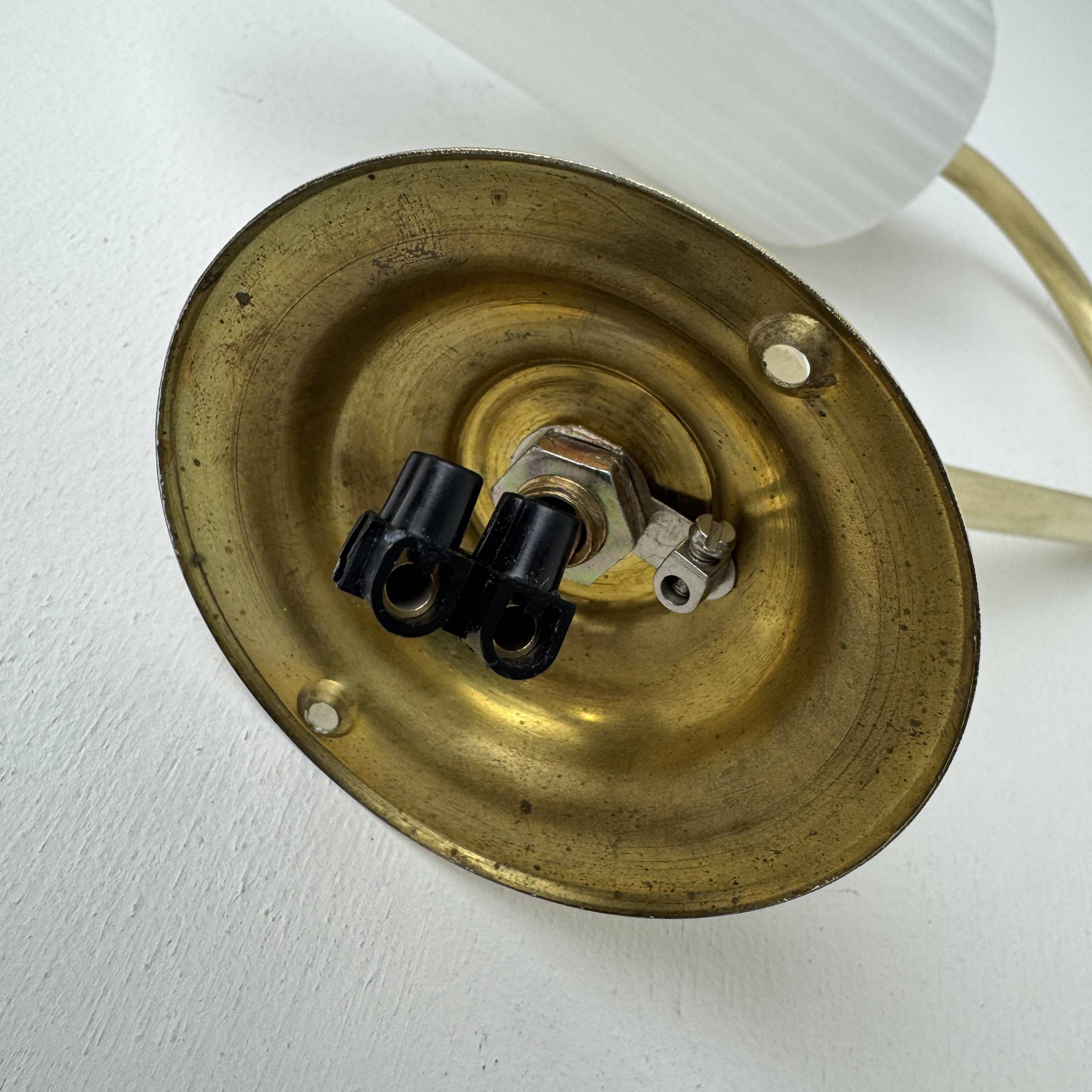 A pair of vintage opaline and brass wall lights