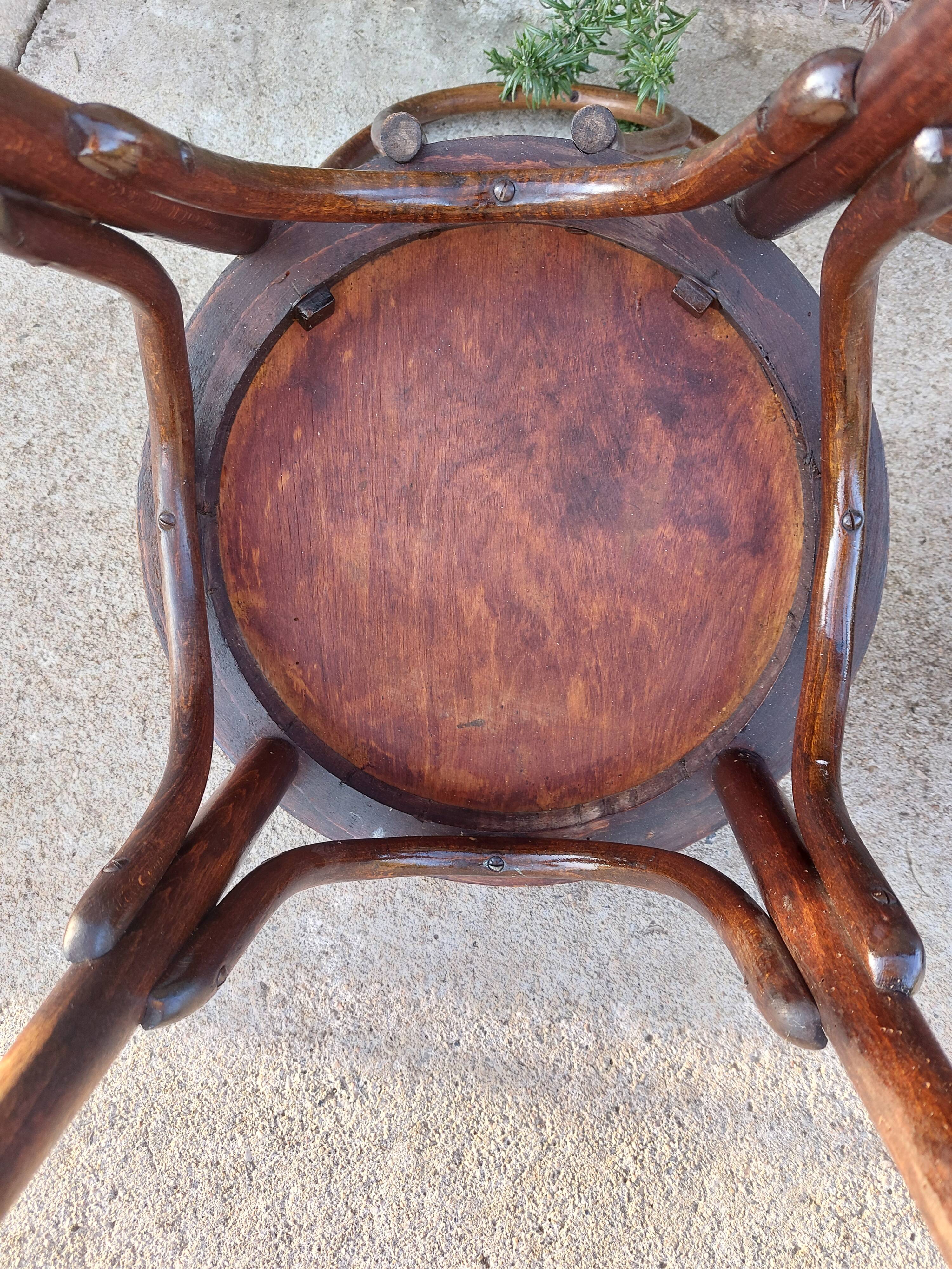 pair of round wooden chairs with a pattern on the seat