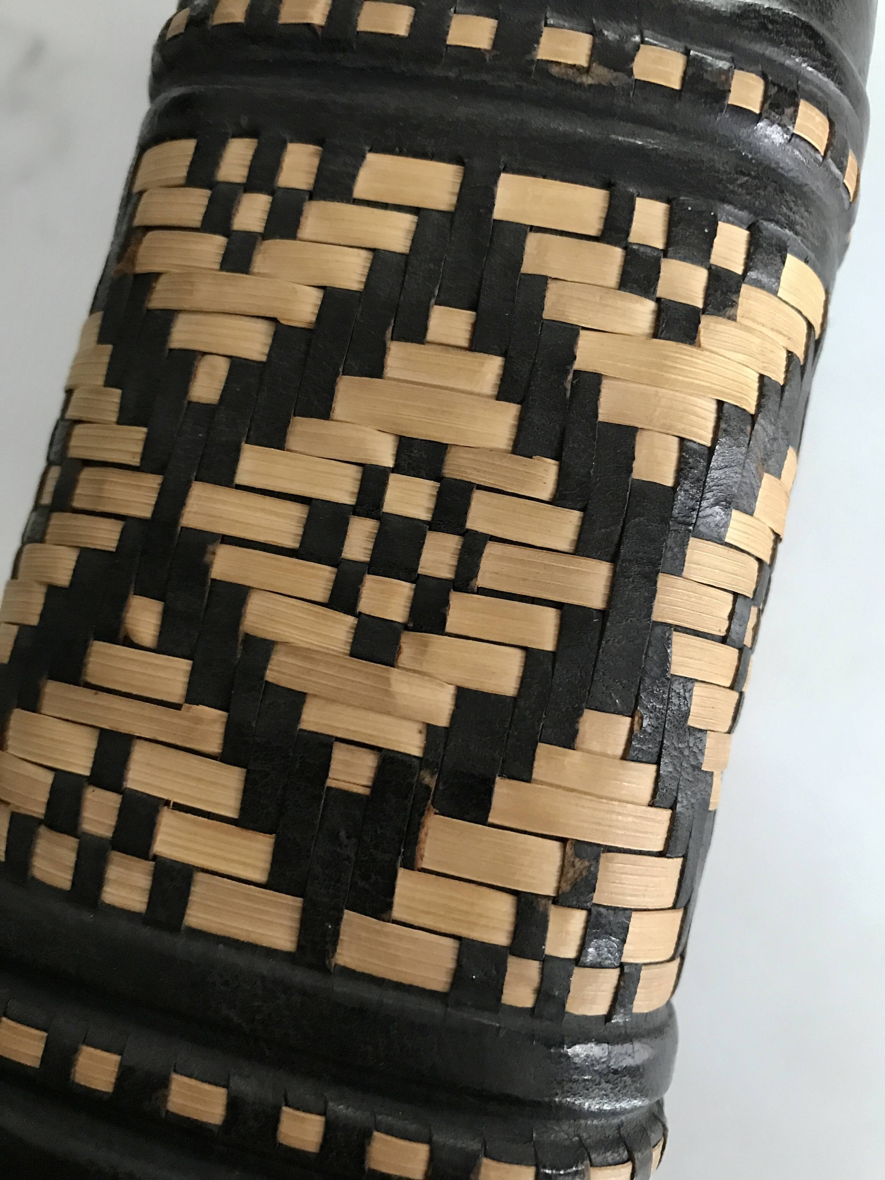 Ethnic decorative bottle in leather and raffia braiding