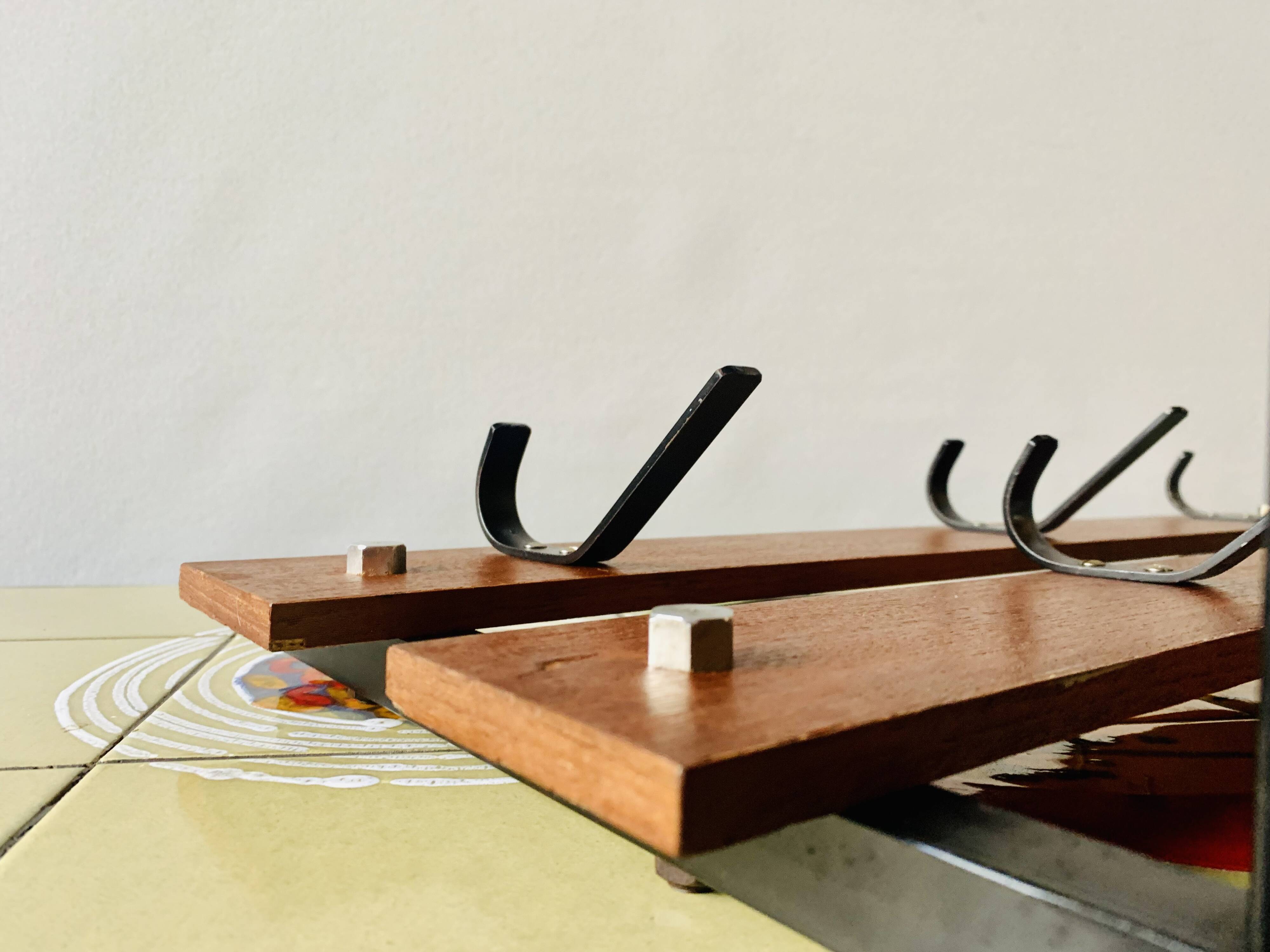 Vintage wall-mounted coat rack in wood and black metal