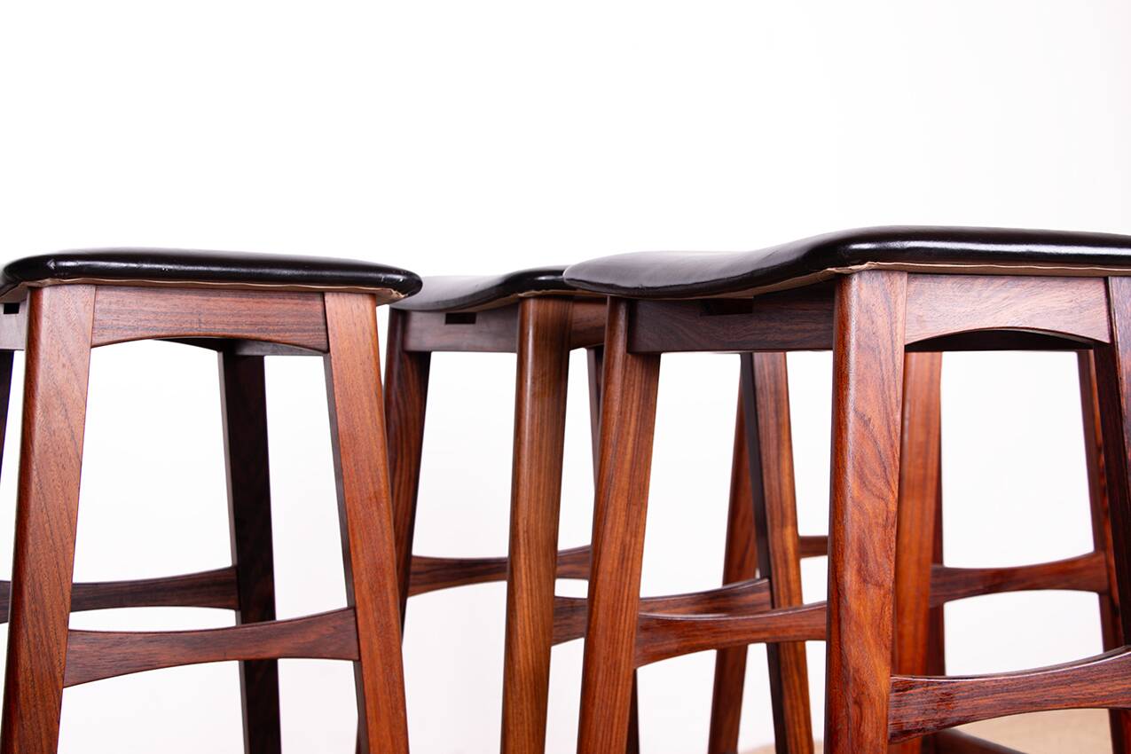 4 Danish high stools, rosewood and black leather, Knud Bent for Dyrlund.