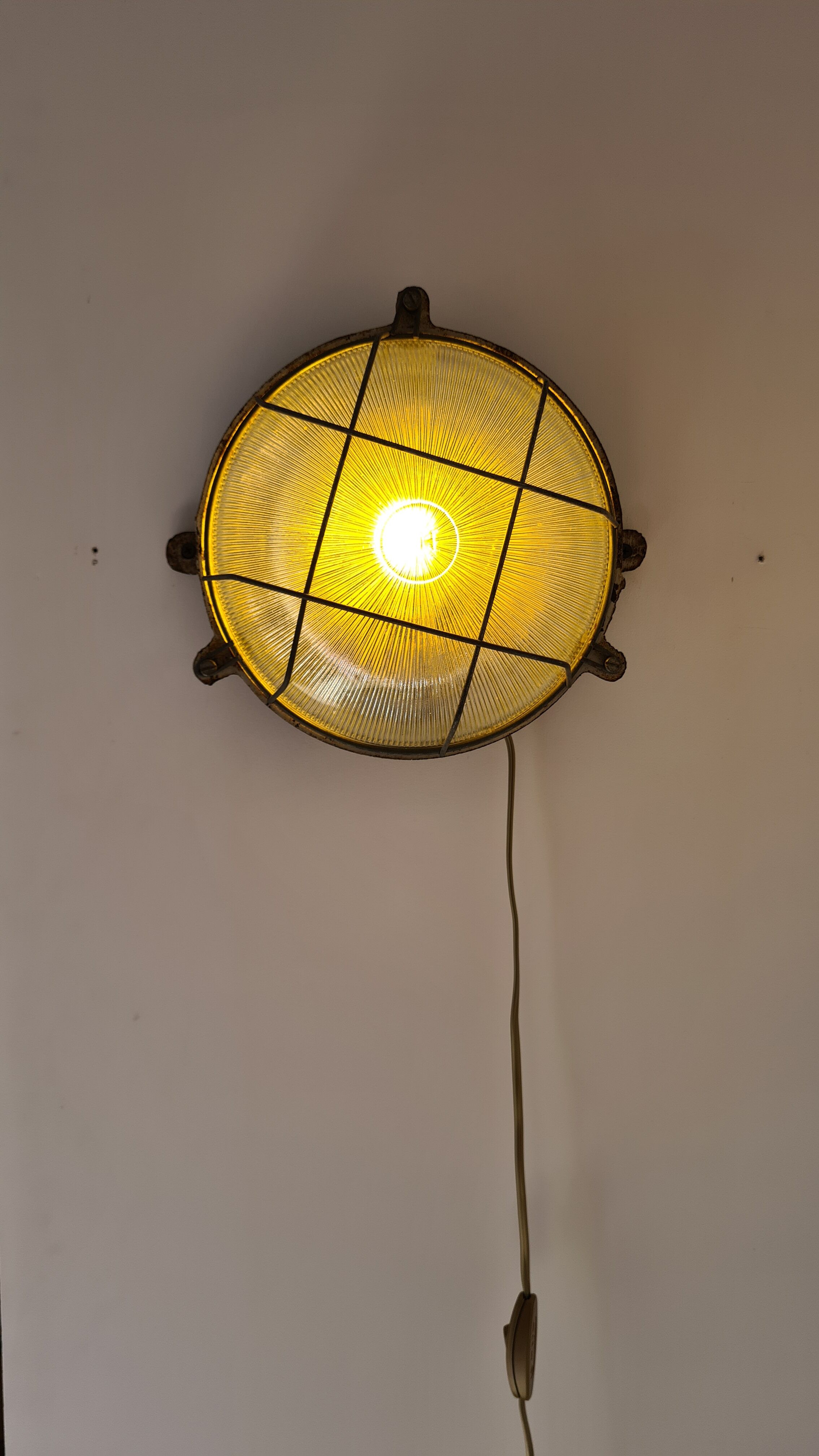 Cast iron porthole wall lamp by TH