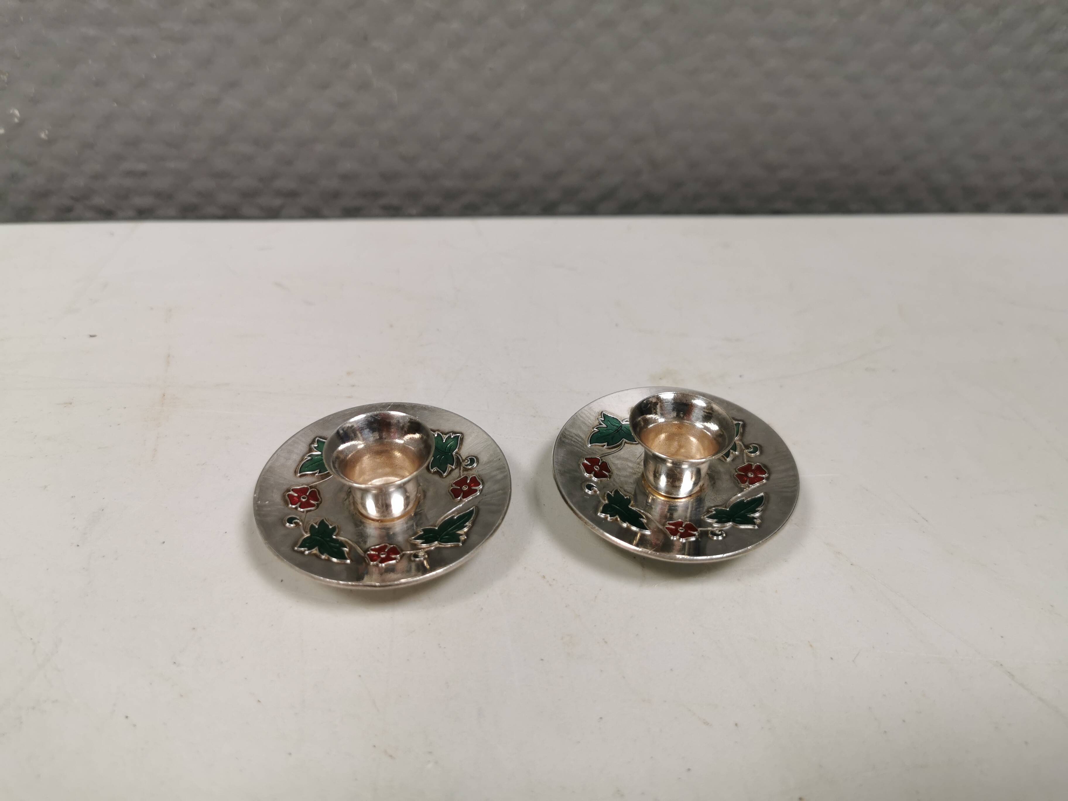 Silver-plated candle holders with inlaid red and green enamel
