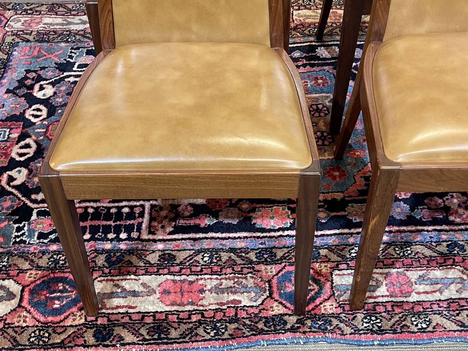 Set of 4 G-Plan chairs in teak and faux leather from the 1970s.