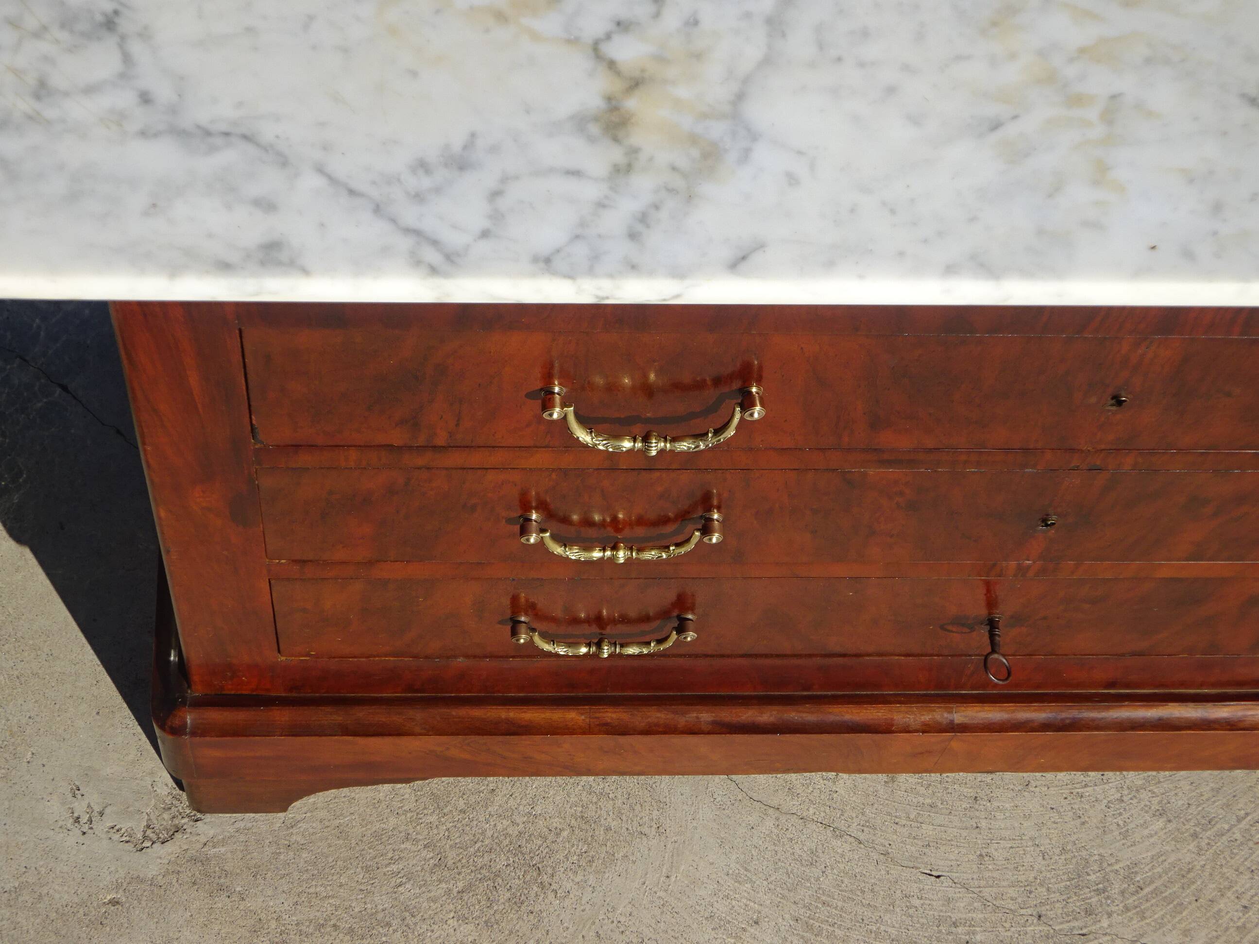 Antique mahogany chest of drawers with white marble.