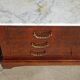 Antique mahogany chest of drawers with white marble.