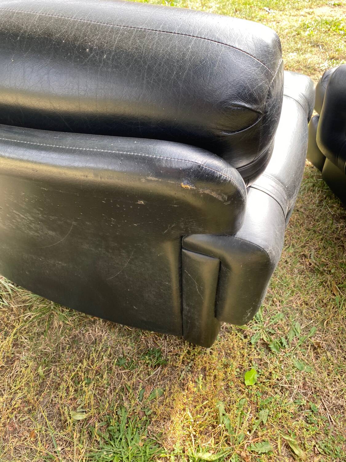 Pair of black imitation leather armchairs
