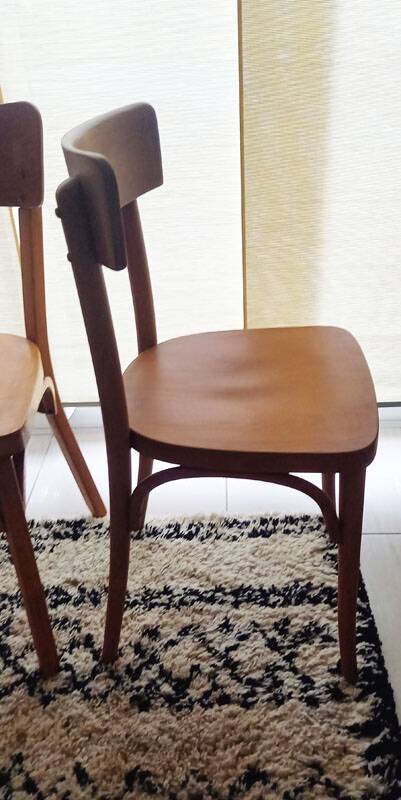 Set of 4 light wood bistro chairs stamped Baumann and Thonet.