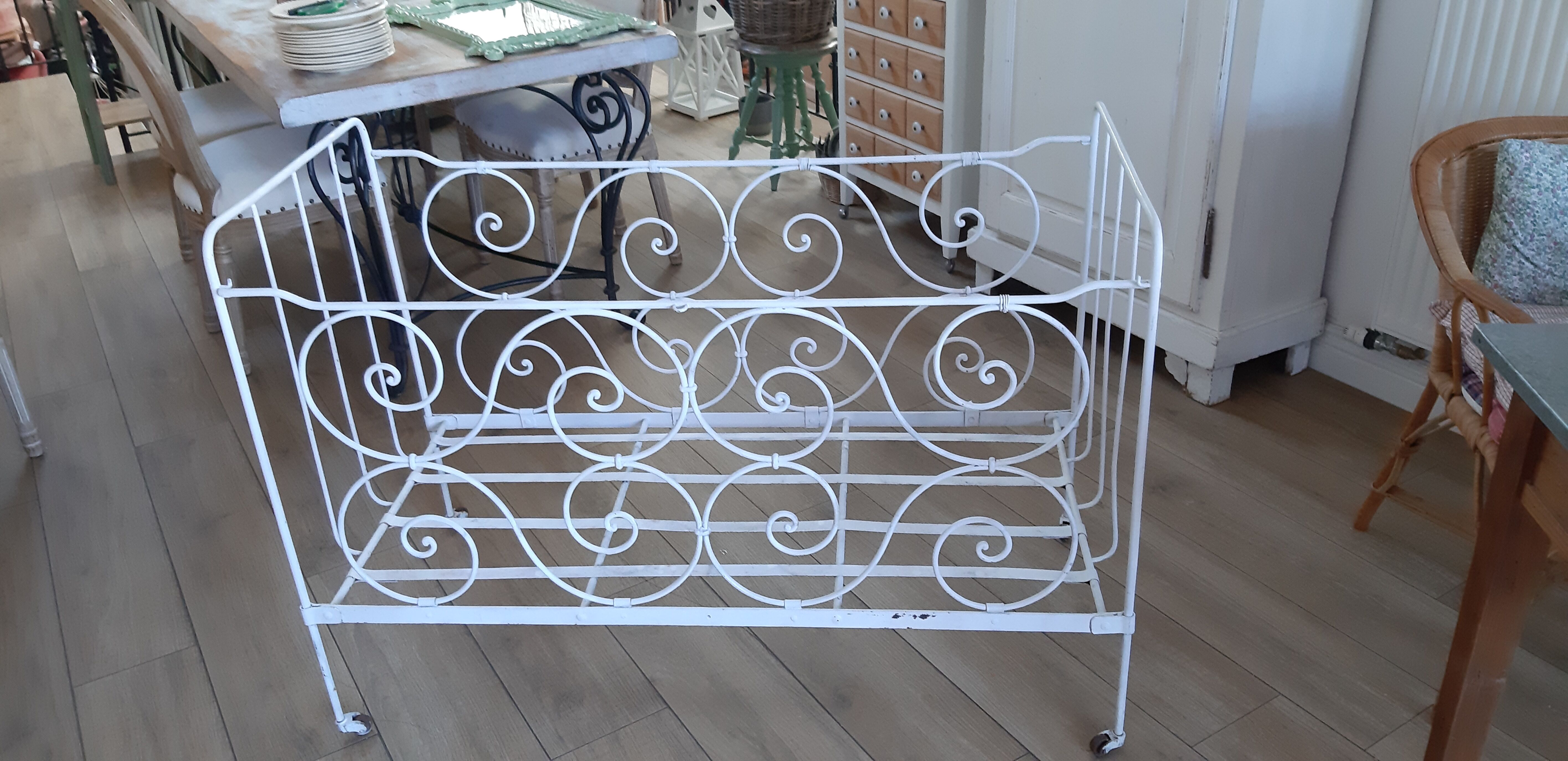 Wrought iron baby bed. Or bench seat of your choice