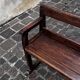 Old wooden bench with backrest and armrests