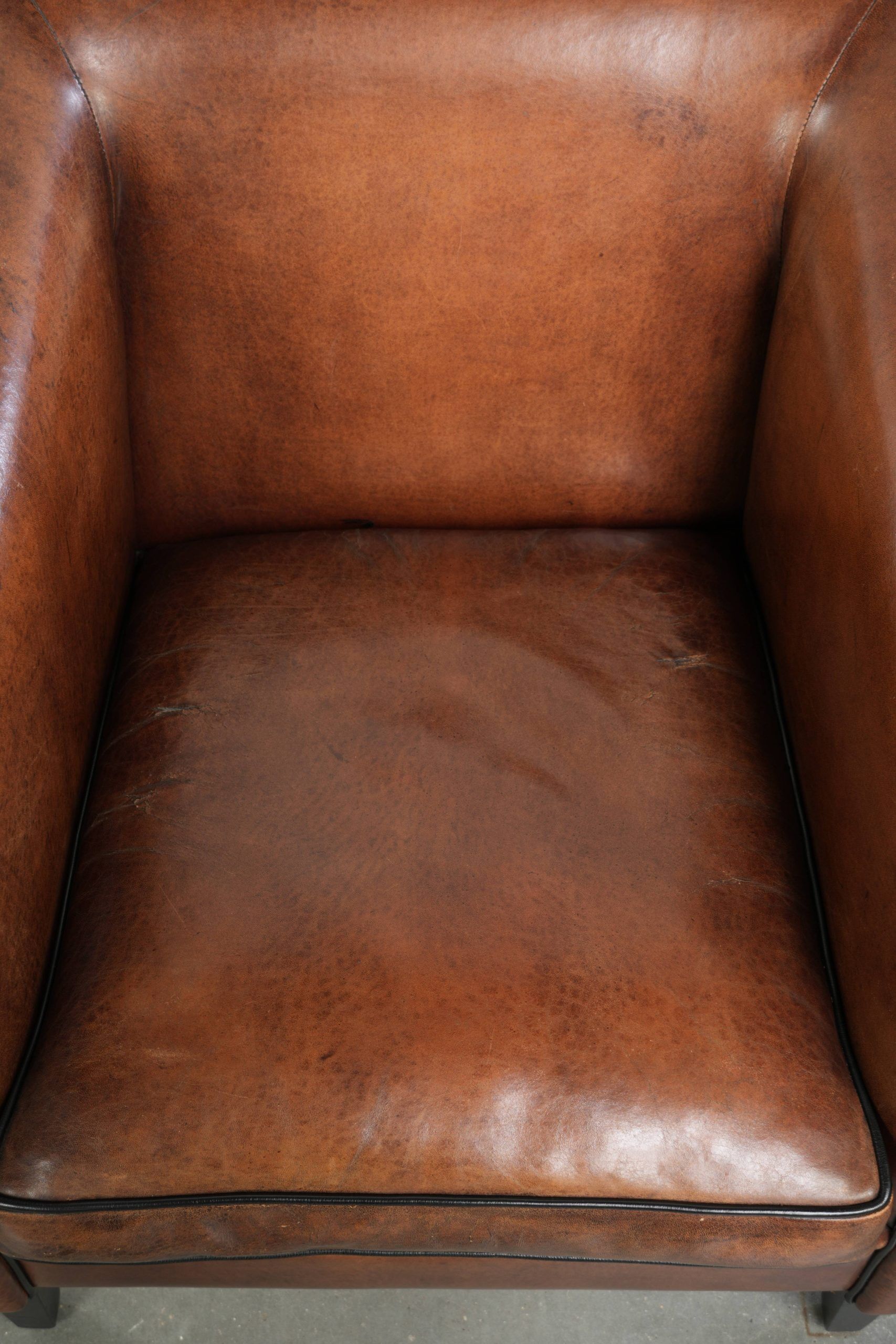 Sleek sheepskin Art Deco design armchair with black piping