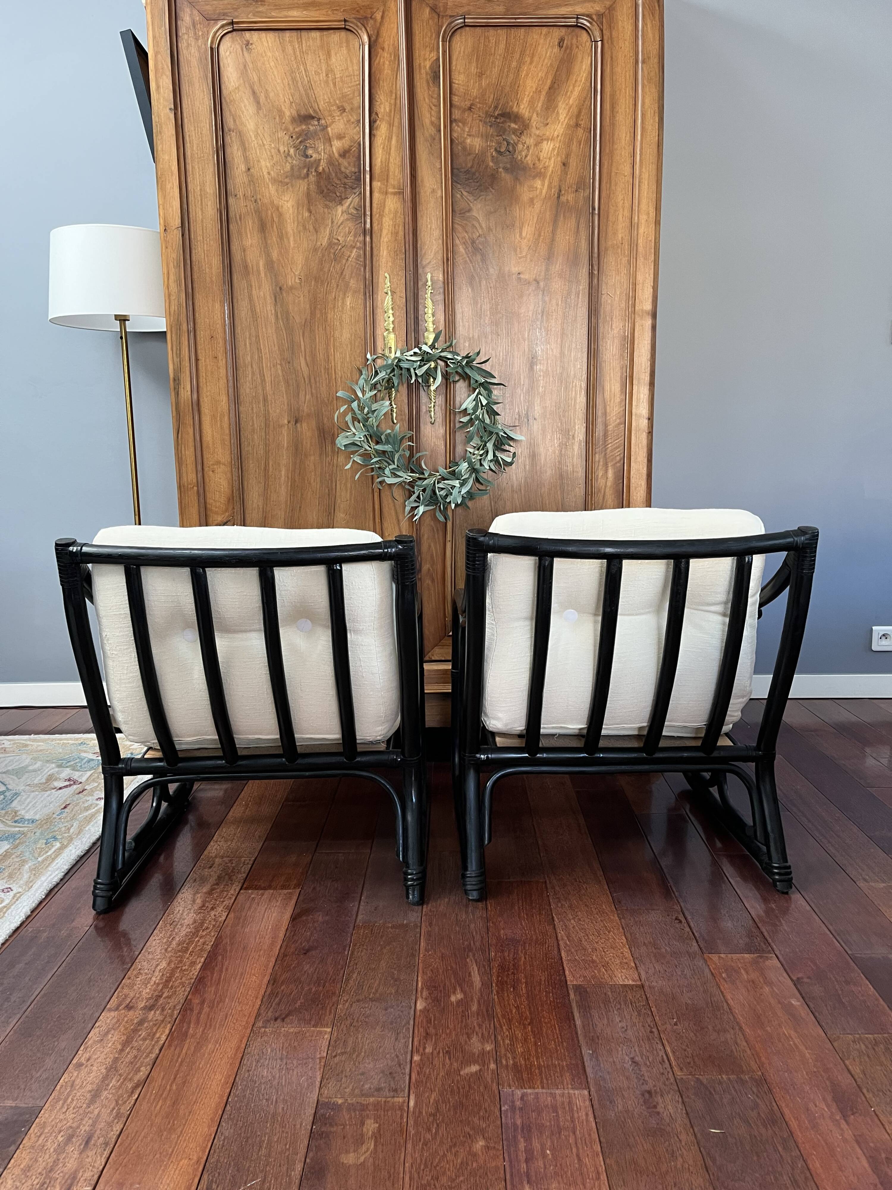 Set of two vintage black and white bamboo chairs.