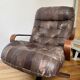 1970s Scandinavian armchair in curved laminated wood with a leather seat.