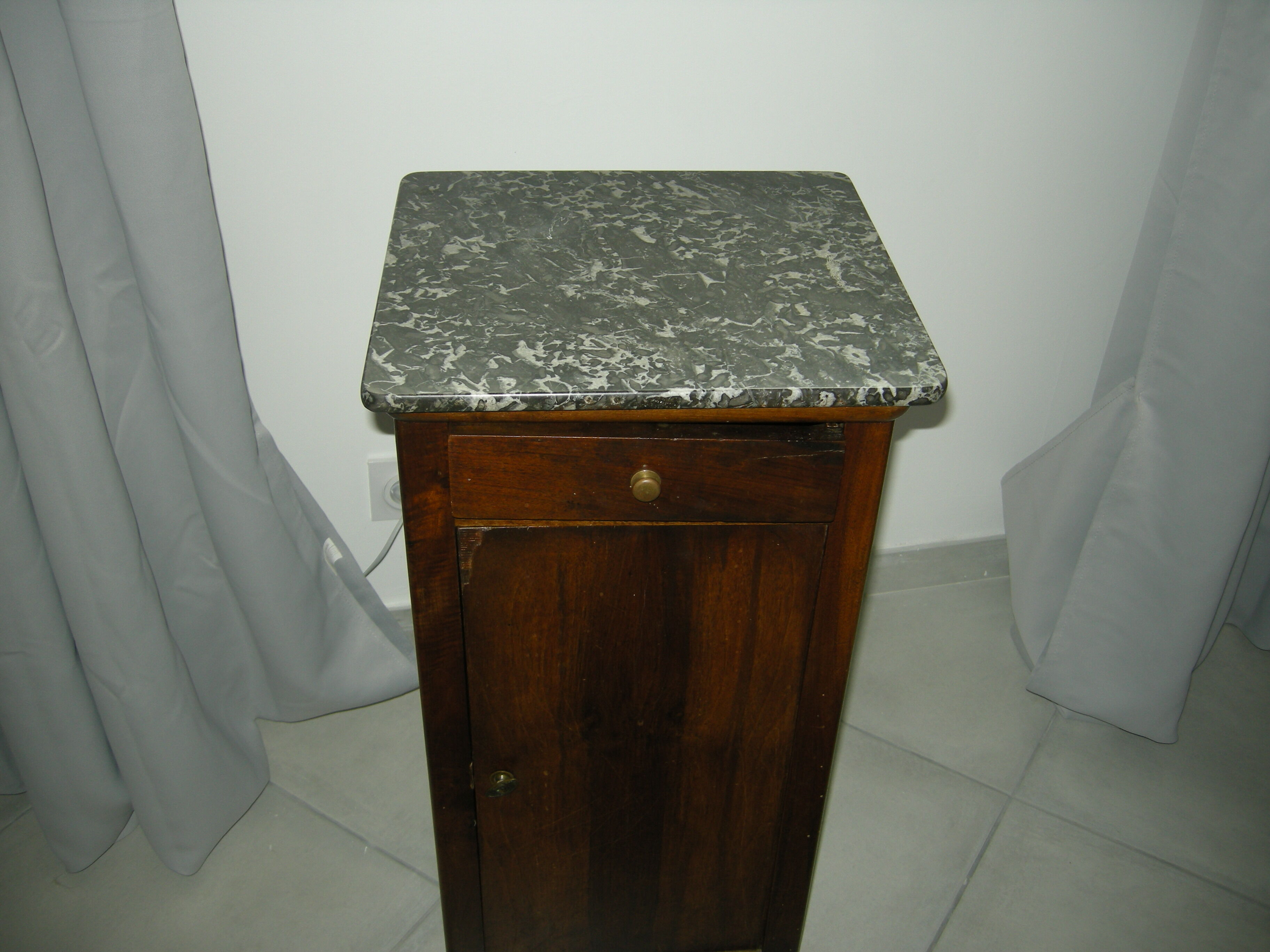 Walnut bedside table on marble