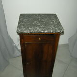 Walnut bedside table on marble