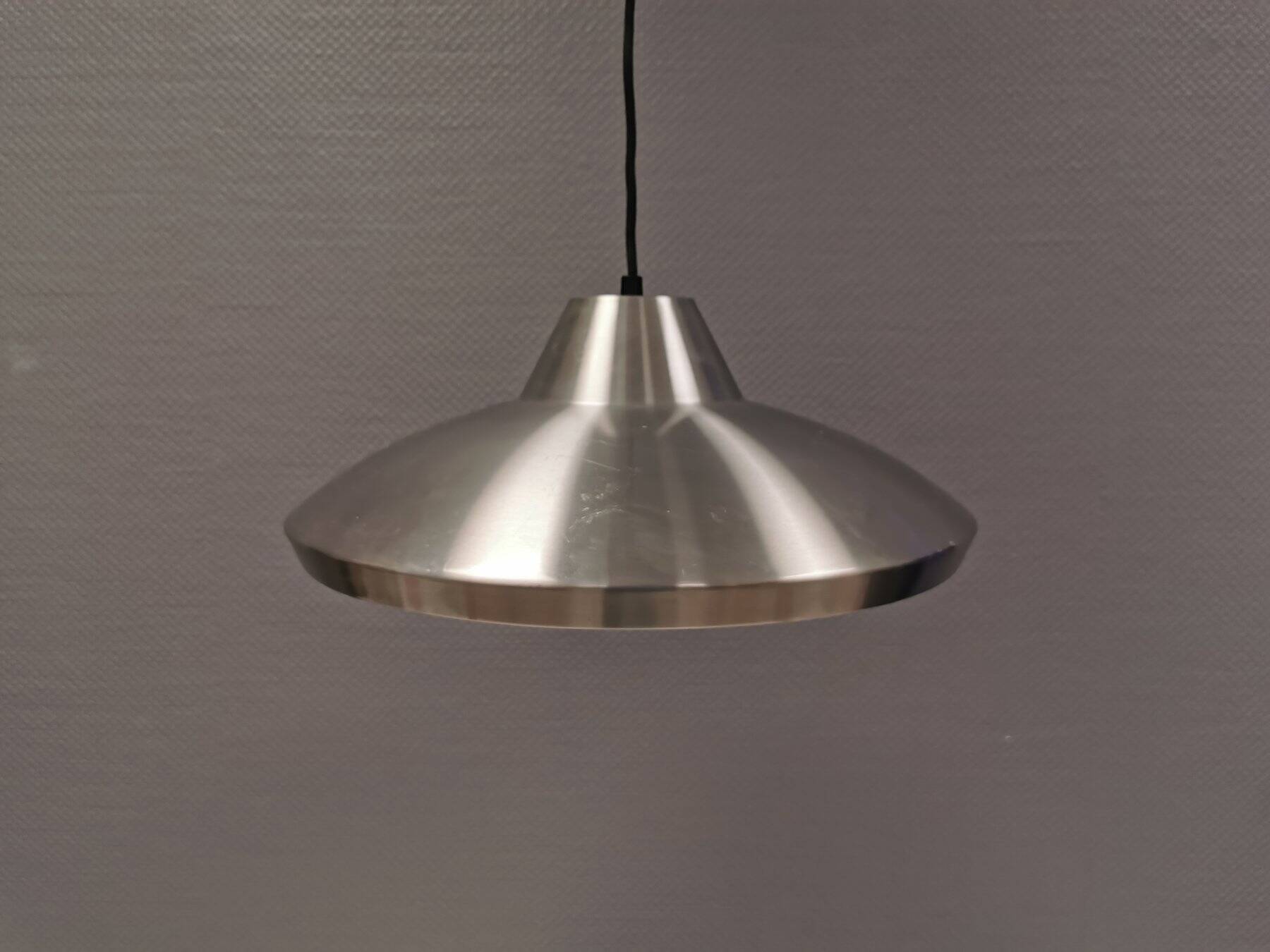 Slim silver-colored hanging lamp with a large diameter. Denmark 1980s