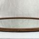 Oval beveled mirror surrounded by light wood dimension: height -74,5cm- width -38,5cm- prof-2cm-