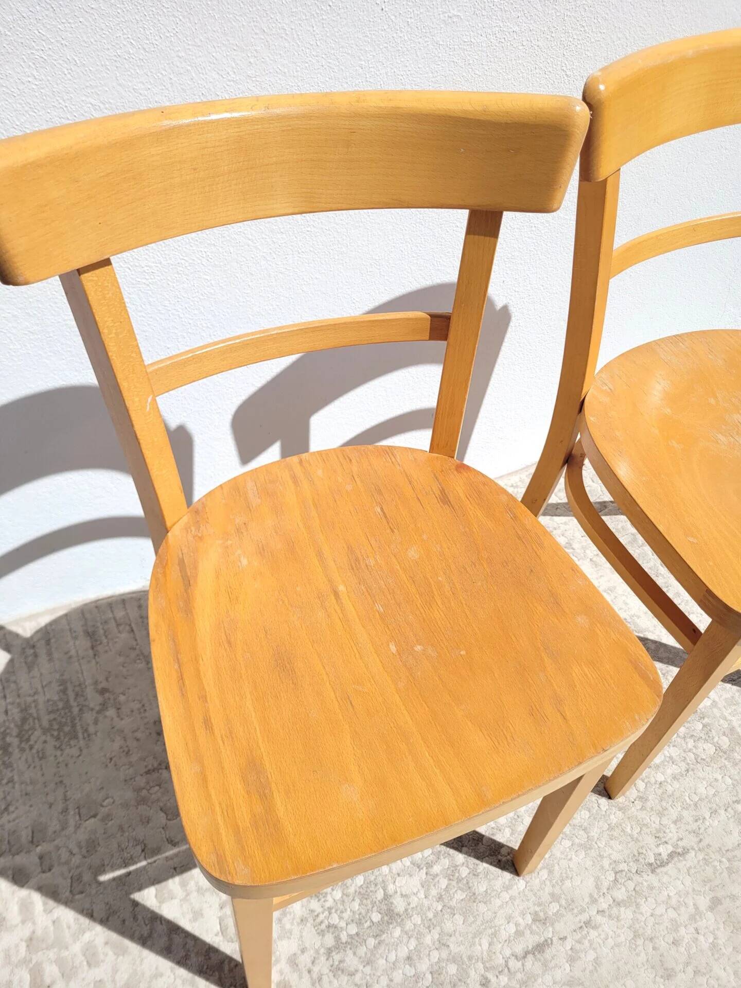 Pair of bistro chairs in light beech.