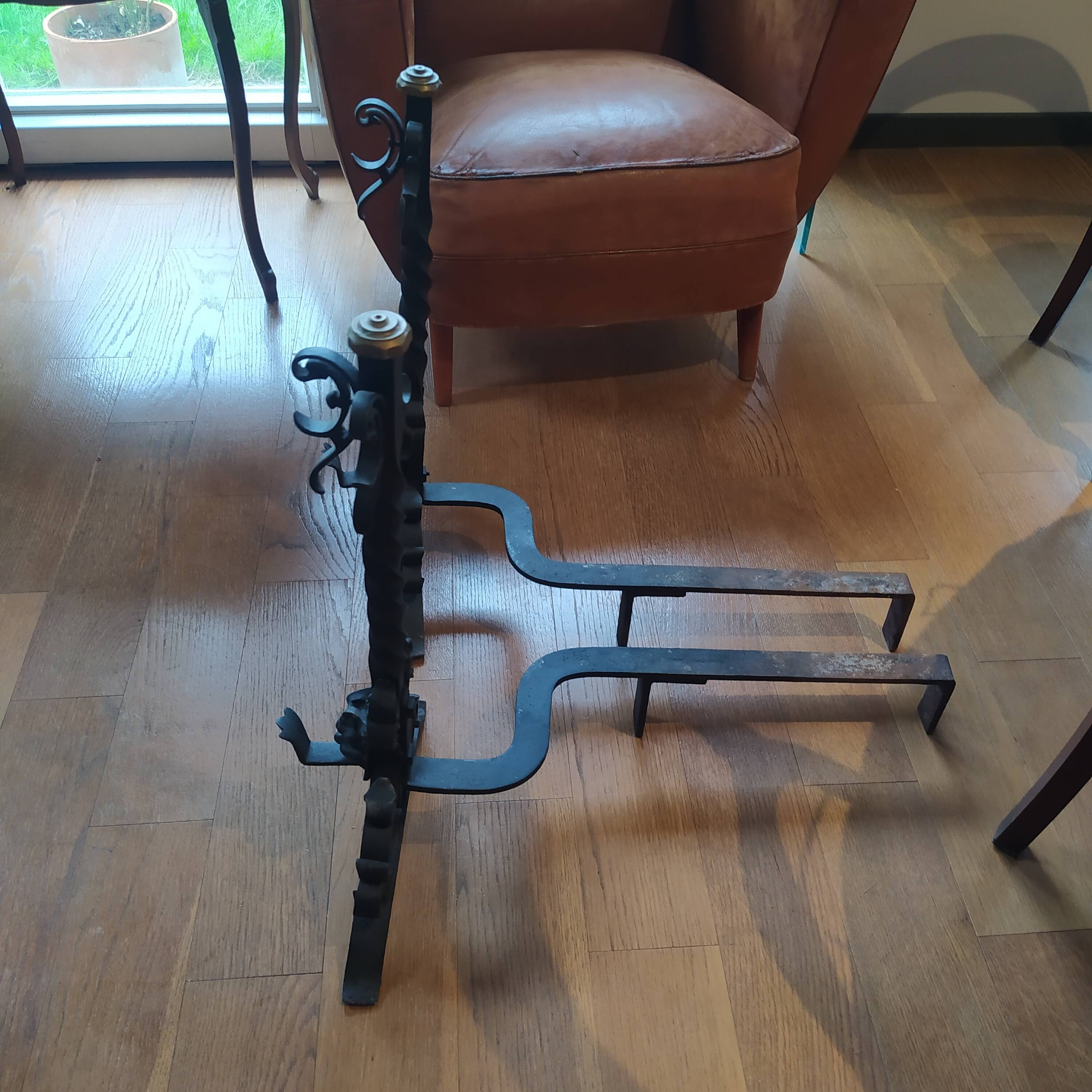 pair of large 20th century metal andirons with mascaron decoration