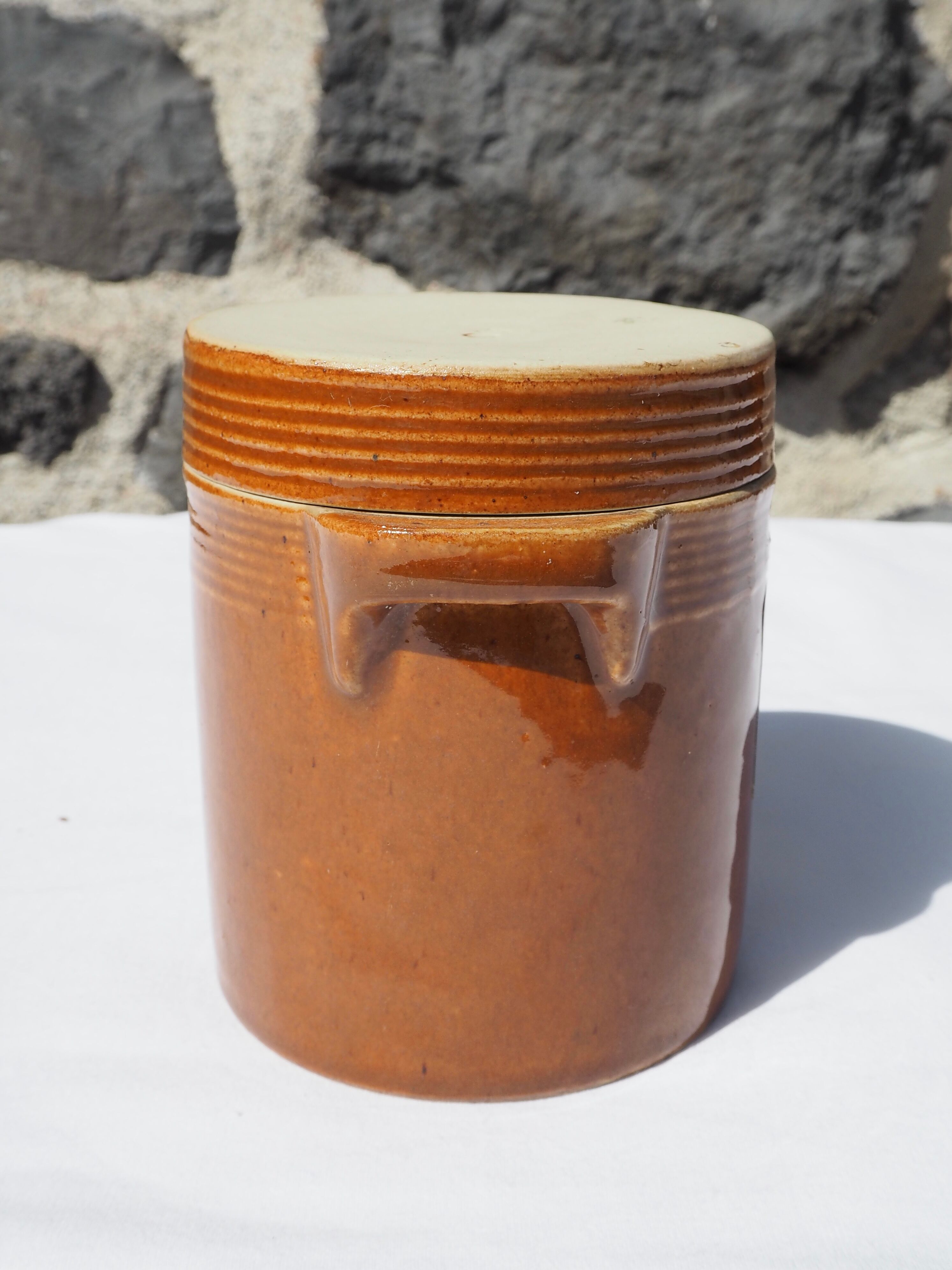 Trio of stoneware pots with lids