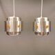 Two Space-Age hanging lamps, in silver-coloured aluminium with orange prisms.
