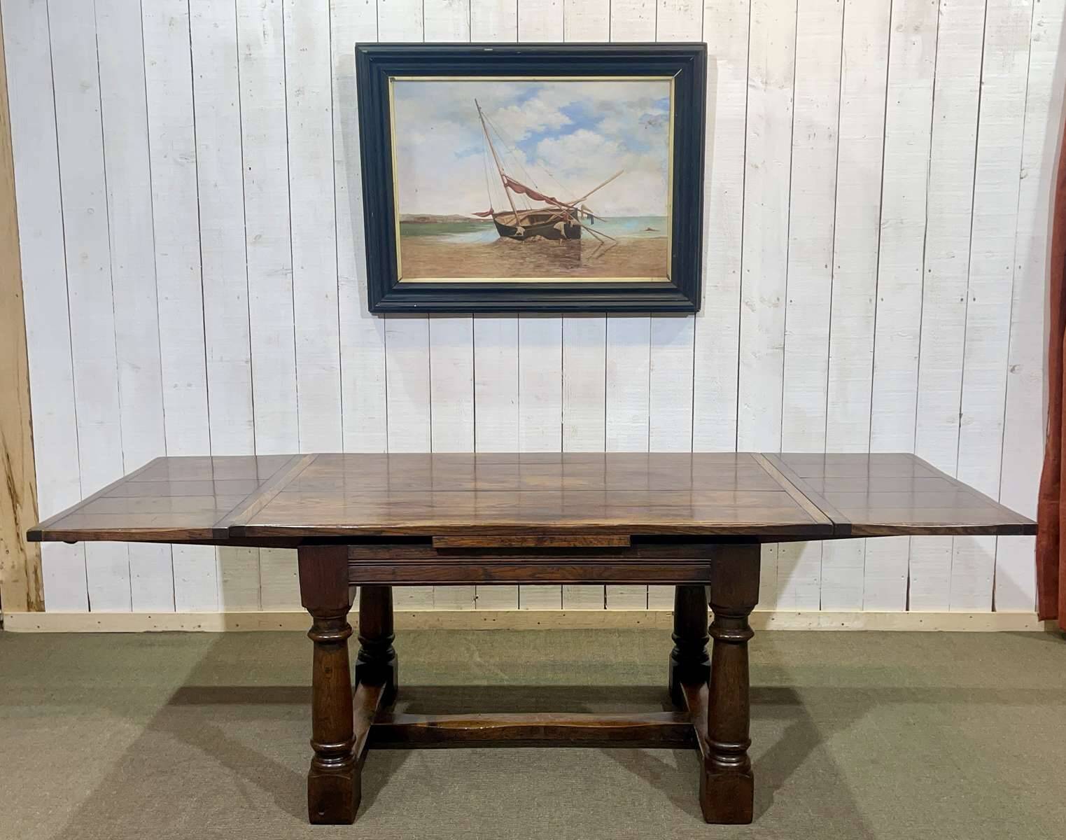 English monastery table with extensions from the late 19th century in elm and oak.
