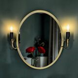 Oval wall mirror in gilded brass with double sconces – 1950s/60s
