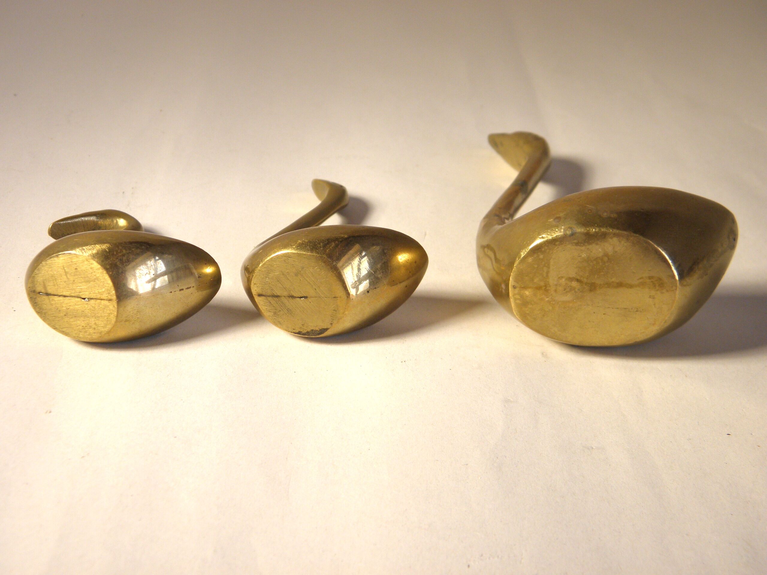 Trio of brass swans