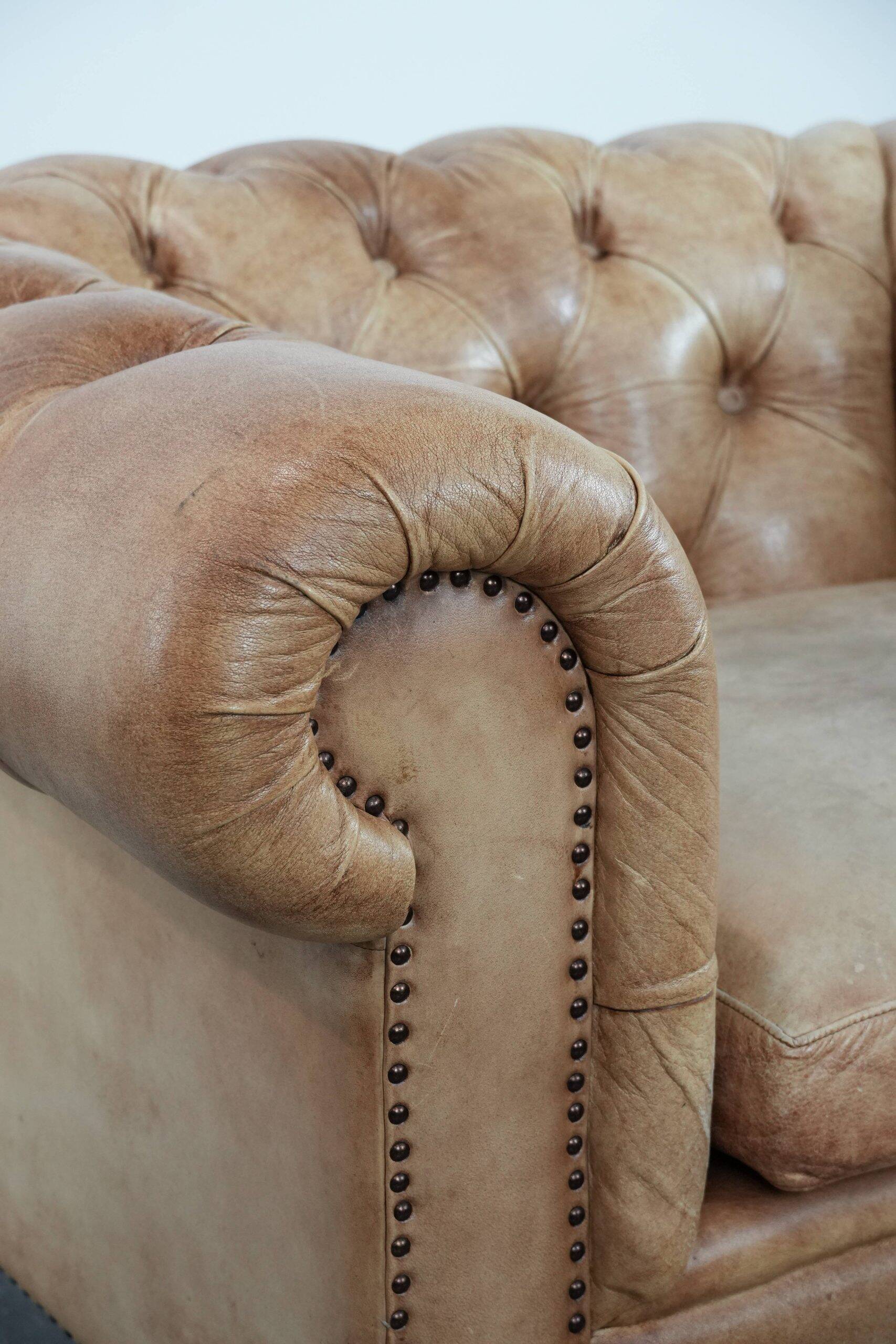 Chesterfield armchair made of cowhide leather in a light cognac colour