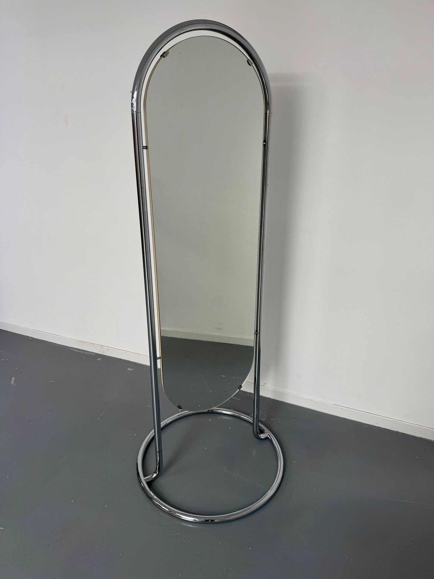 Large freestanding chrome metal full-length mirror in 1970s design.