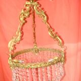 circular chandelier with a brass frame equipped with crystal drops
