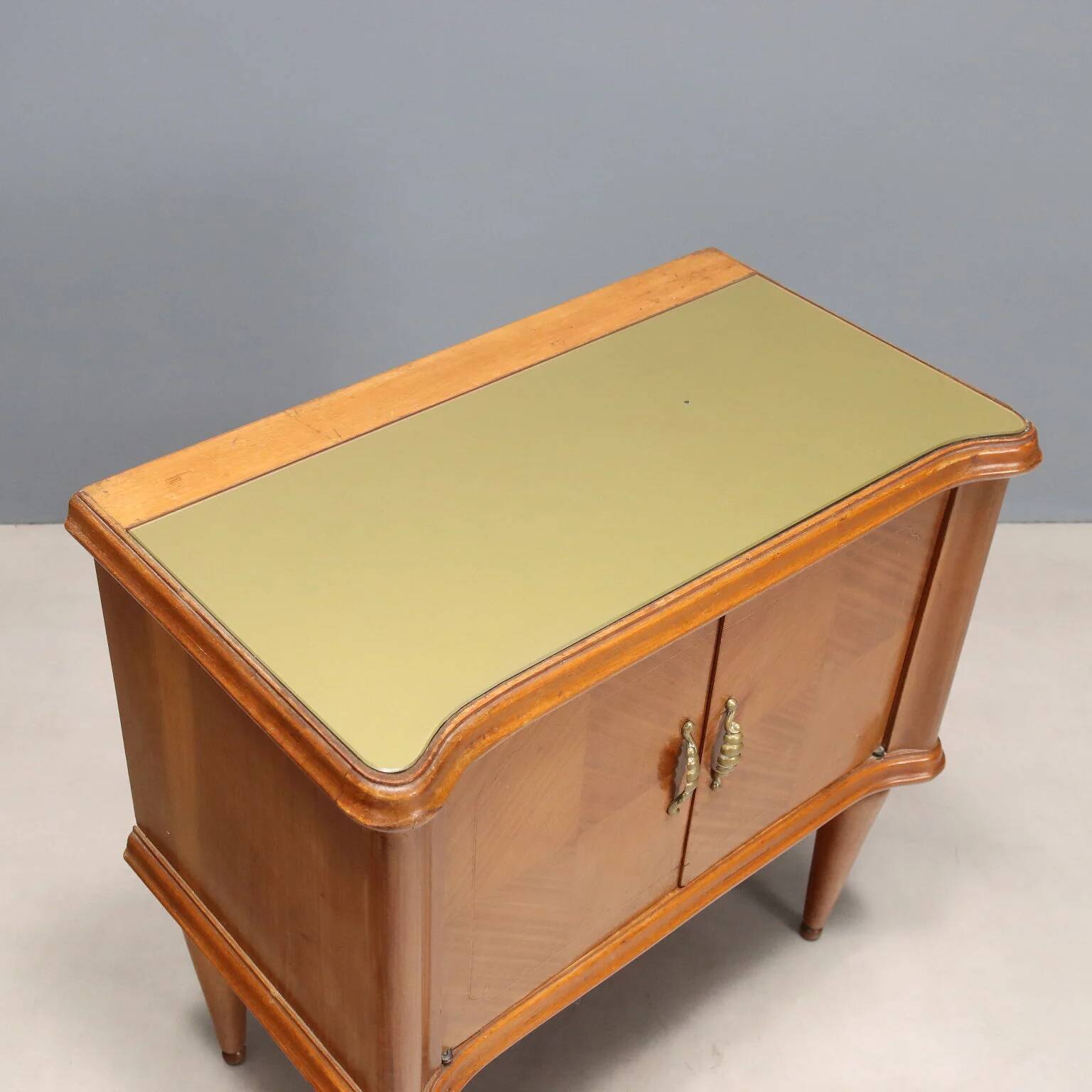 Pair of wooden and glass bedside tables from the 1950s.