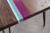 Solid oak coffee table with colored bands on pin legs