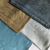 Suite of four tinted antique napkins