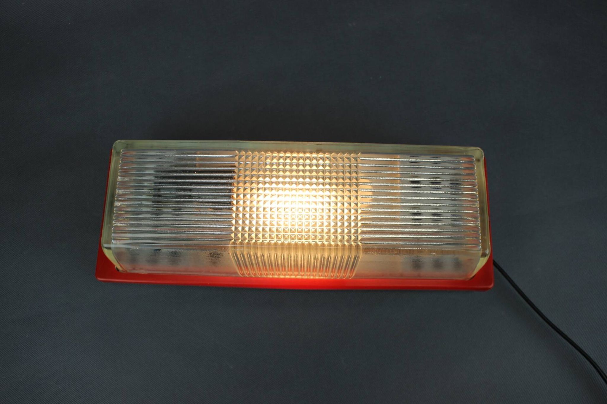 1970s Czech space age wall light with red plastic and glass.