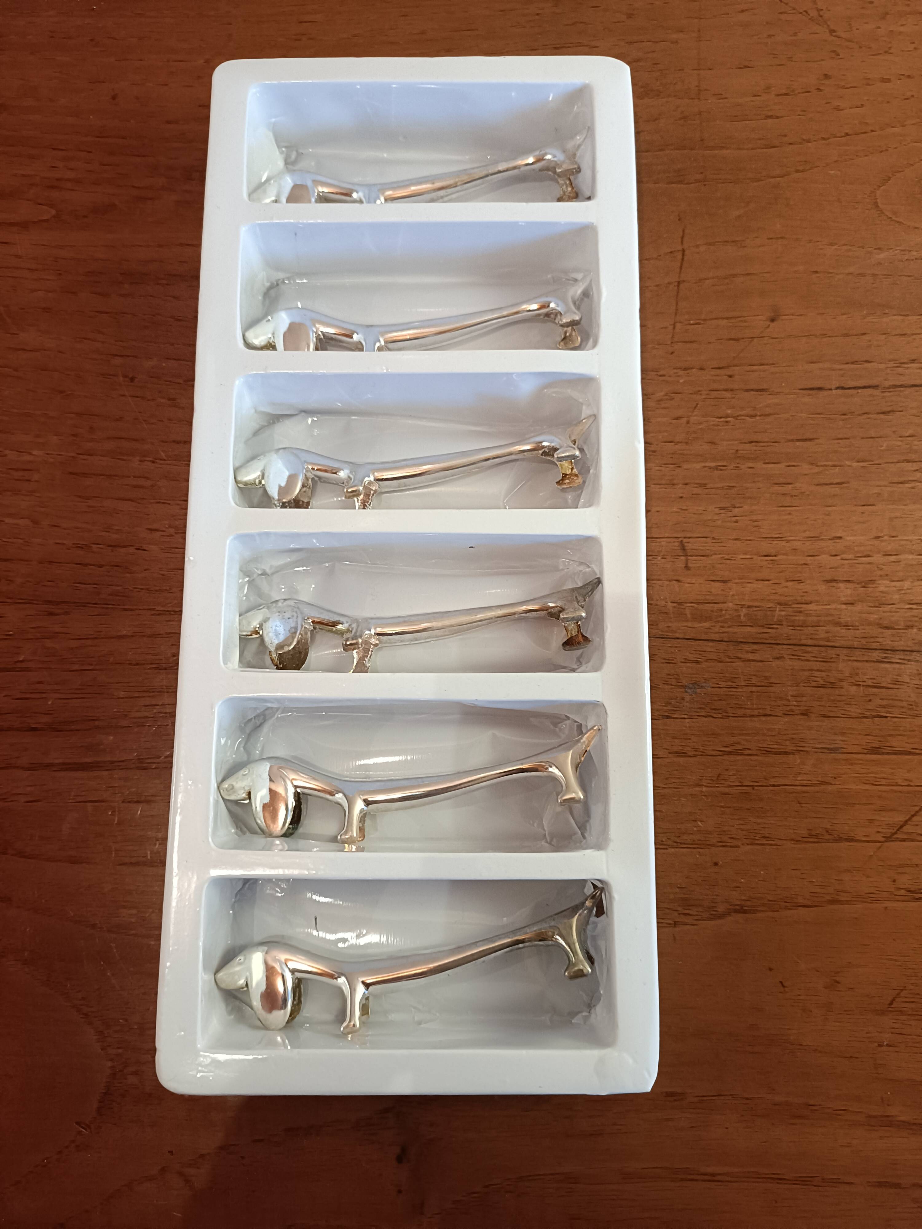 Six silver metal knife holders basset hound