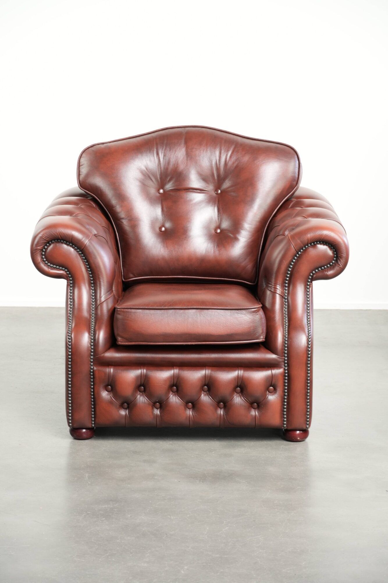Brown cow leather Chesterfield armchair in a unique design