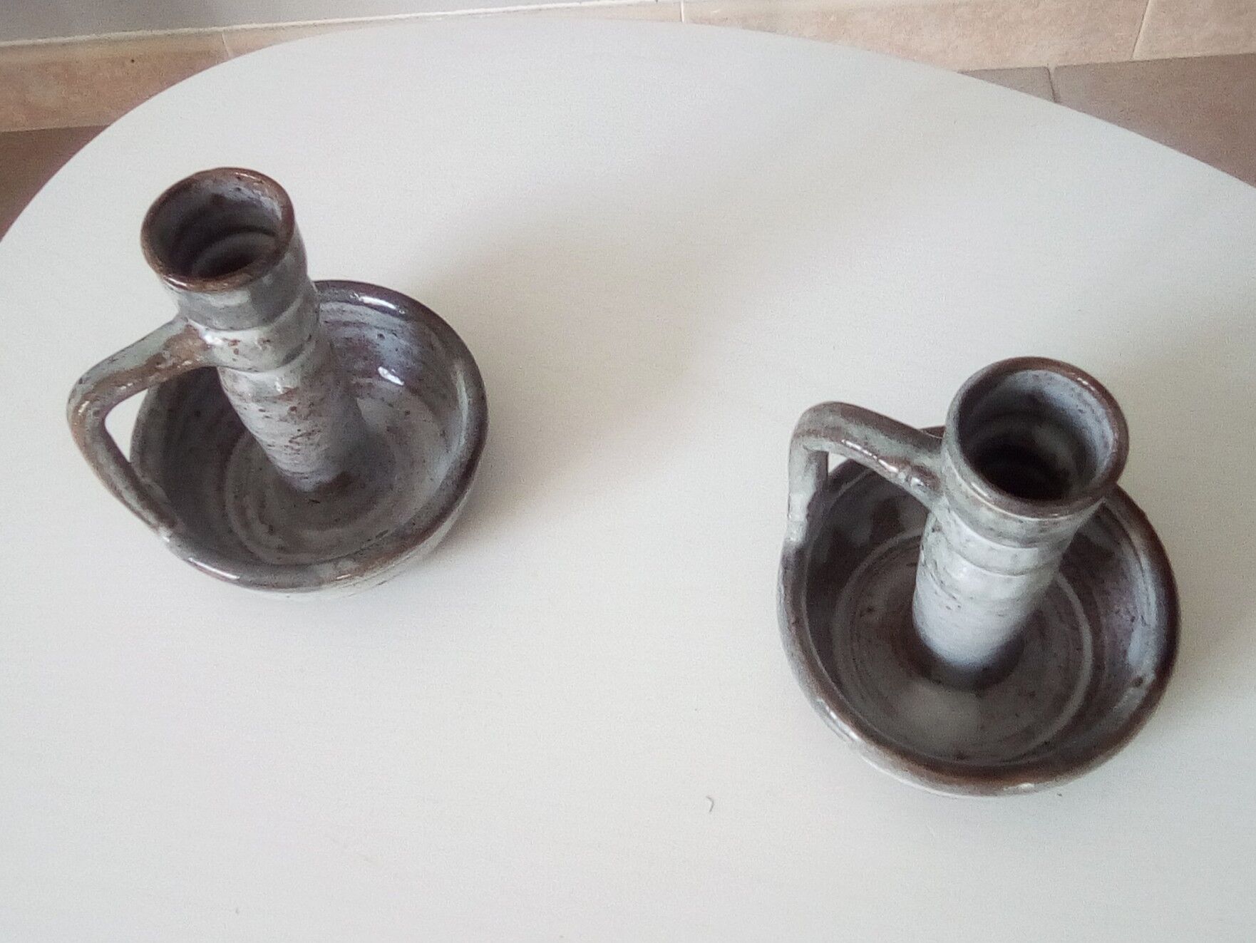 Pair of speckled sandstone candle holders