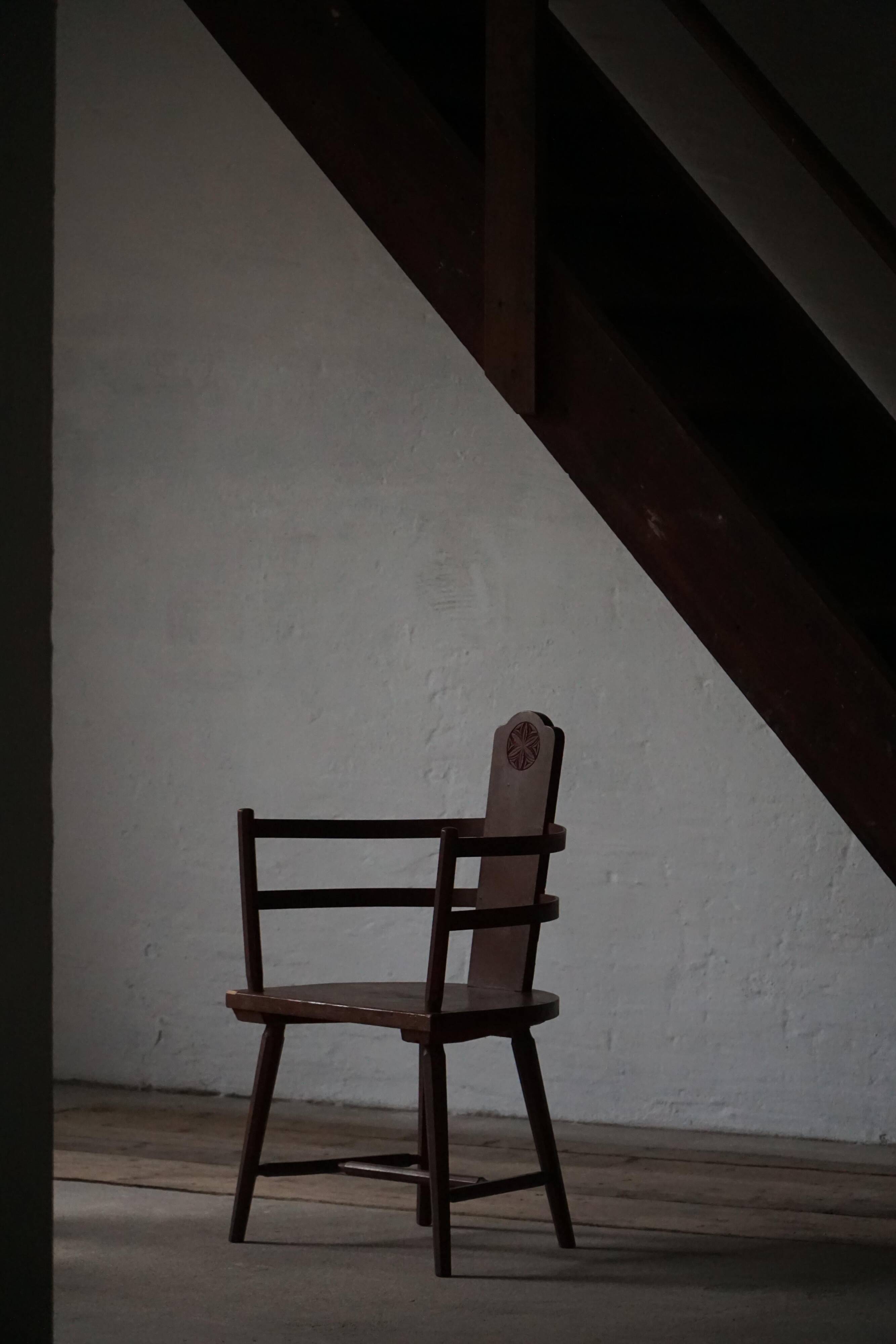 Pair of Scandinavian wooden armchairs with hand-carved folk motifs, 1920s.